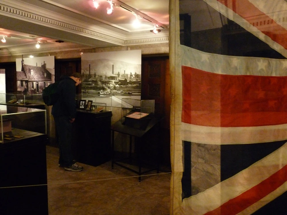 “Andrew Carnegie: Forging Philanthropy” exhibit, with Skibo Castle flag in the foreground.