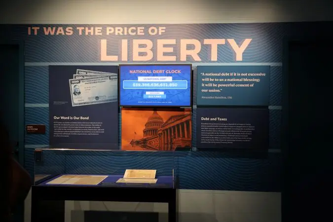 This exhibit features a live national debt clock, broken down per US citizen