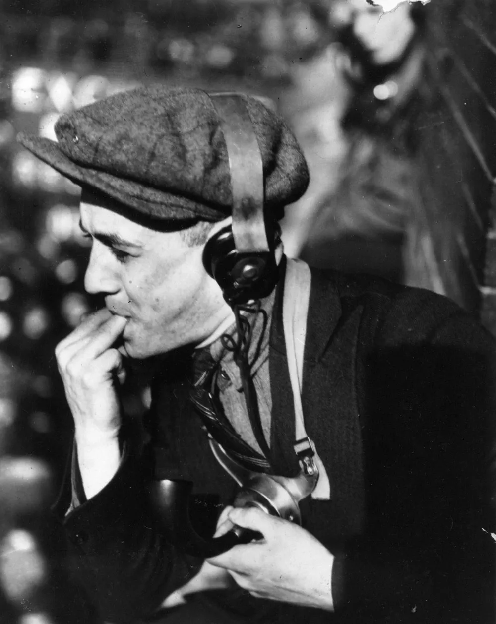 A clerk perches on a ledge to signal a trader below at the Curb Exchange, precursor to the American Stock Exchange.