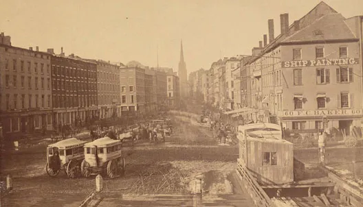 First photo: This picture, circa 1860, is the earliest known photograph of Wall Street. Taken from a ship's deck looking west on Wall Street, Trinity Church towers over the neighboring buildings.