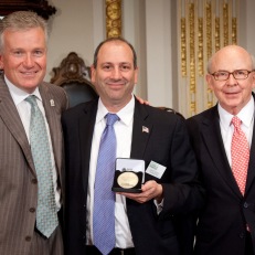 MoAF Chairman Richard Sylla and President David Cowen receive closing bell medallions from NYSE Euronext CEO Duncan Niederauer. Photo courtesy of Valerie Caviness.